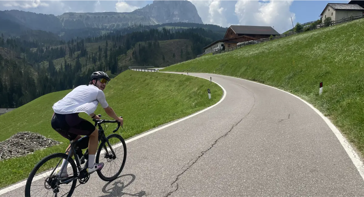 Cyclist climbing Passo delle Erbe in the Dolomites