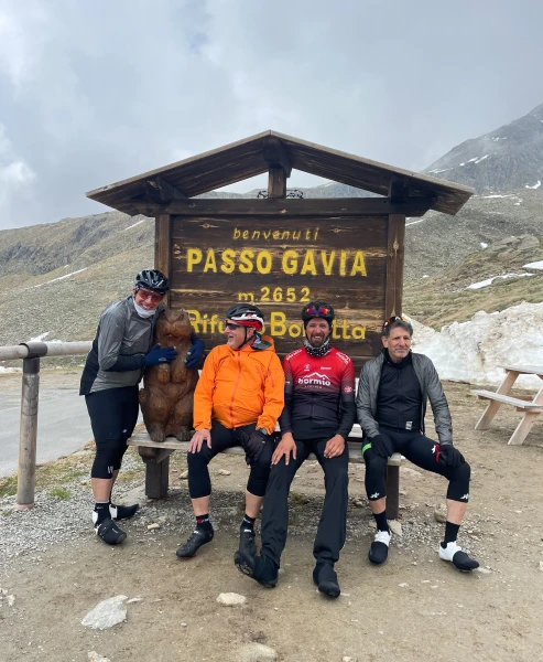 Cyclists at the summit of Passo Gavia in the Italian Alps