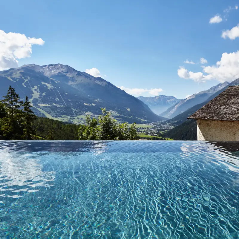 Infinity pool overlooking the Alps at the Roman Baths in Bormio during the Stelvio and Dolomites Bike Tour
