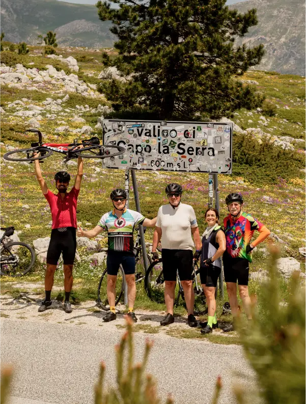 Cyclists climbing to Valico di Capo la Serra beneath the Gran Sasso mountains in Abruzzo