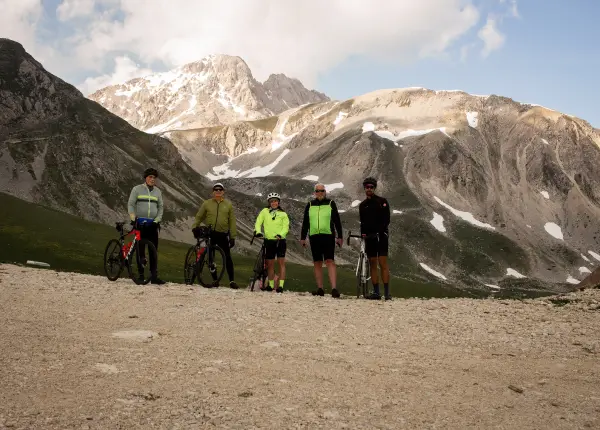 Cyclists at the top of Campo Imperatore with the Gran Sasso mountains in the background, Abruzzo