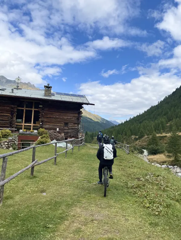 Cyclists exploring easy trails and quiet alpine backroads on the E-bike the Alps tour