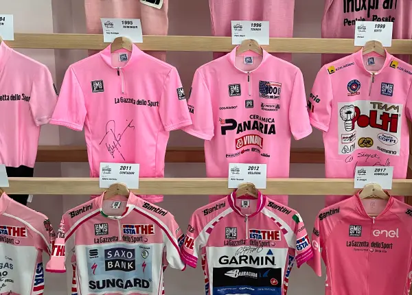 Collection of Giro d’Italia pink jerseys showcased at the Ghisallo Cycling Museum during the Stelvio to Lake Como Bike Tour