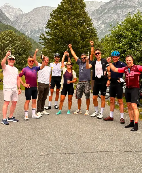 Group of cyclists celebrating with beers after a long ride in the Stelvio and Dolomites Bike Tour