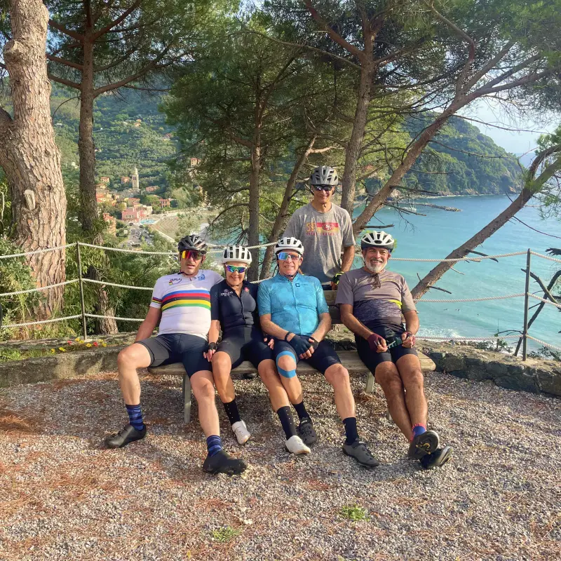 Group of cyclists resting above the Ligurian coast after descending from the Apennines