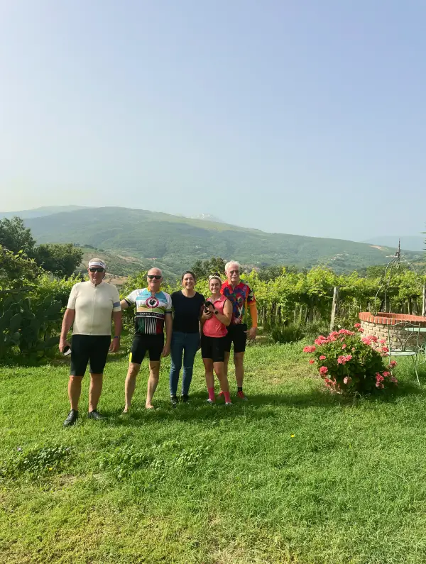 Cycling group enjoying authentic hospitality in the Abruzzo countryside during a Vago Bike Tour
