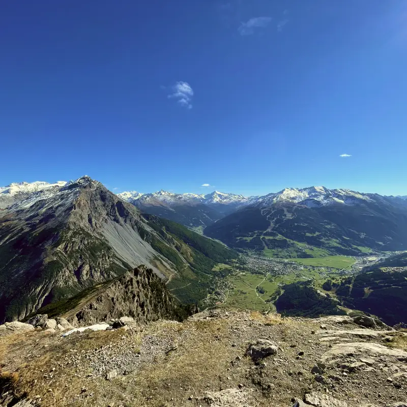 Panoramic view from the Monte Scale summit showing the Bormio Valley and surrounding snow-capped peaks on the E-bike the Alps tour