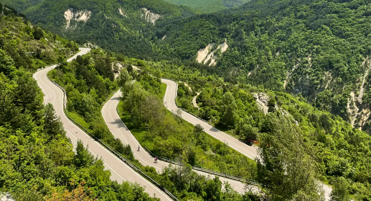 Scenic switchbacks of Passo San Leonardo road surrounded by green valleys in Abruzzo
