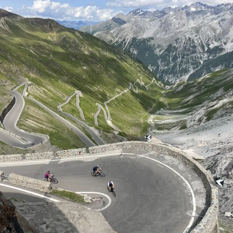 Cyclists climbing the legendary switchbacks of Stelvio Pass
