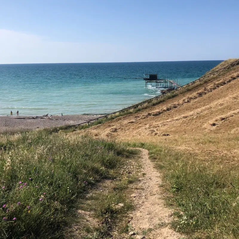 Path leading to the Adriatic Sea and a traditional trabocco fishing hut on the Trabocchi Coast in Abruzzo
