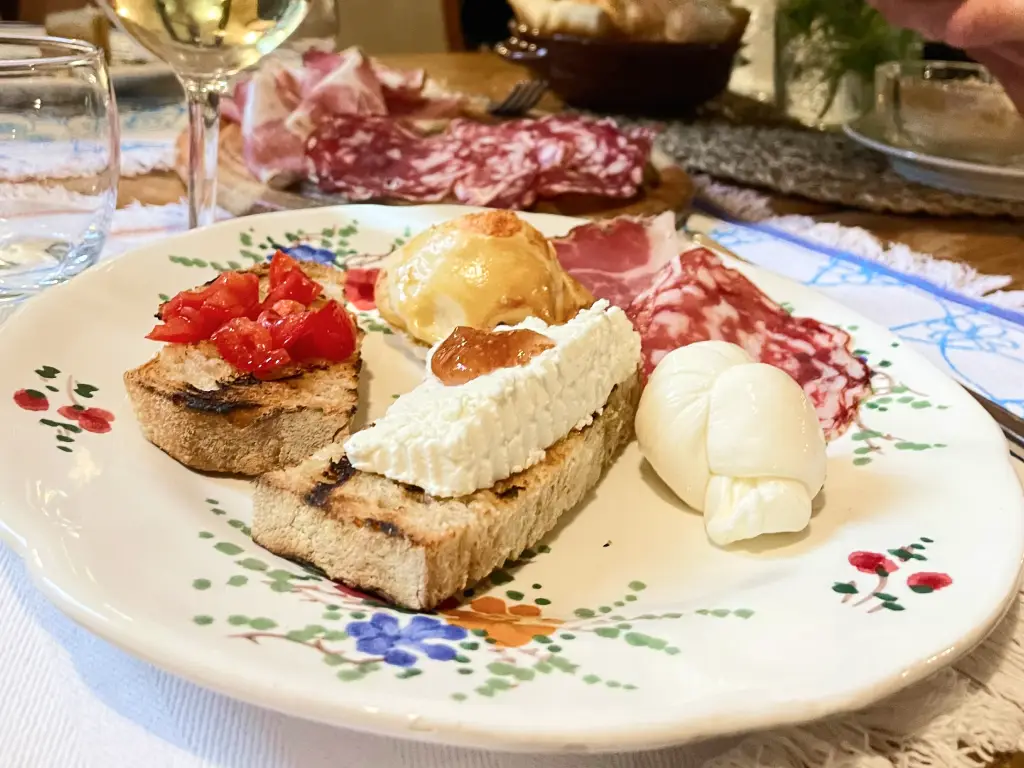 Abruzzo aperitivo with local cheese, cold cuts, and homemade bread served with regional wine