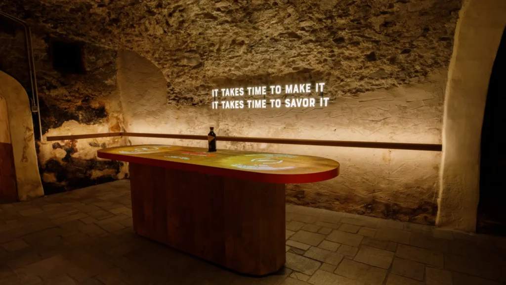 Braulio tasting room inside the historic aging cellar in Bormio with the quote it takes time to savor it