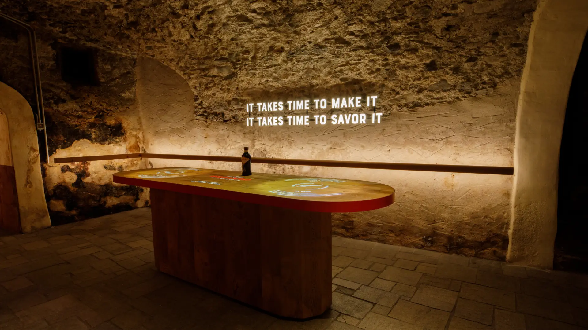 Braulio tasting room inside the historic aging cellar in Bormio with the quote it takes time to savor it