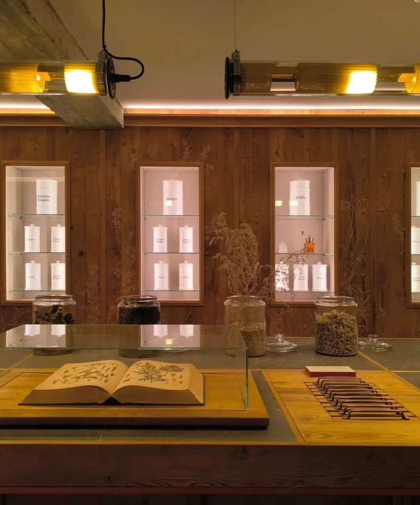 Apothecary-style herb room at Braulio with glass jars, dried botanicals, and an open botanical book