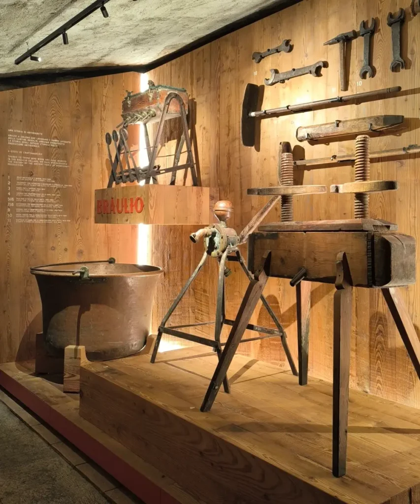 Display of traditional tools and copper vats used in the early Braulio production process
