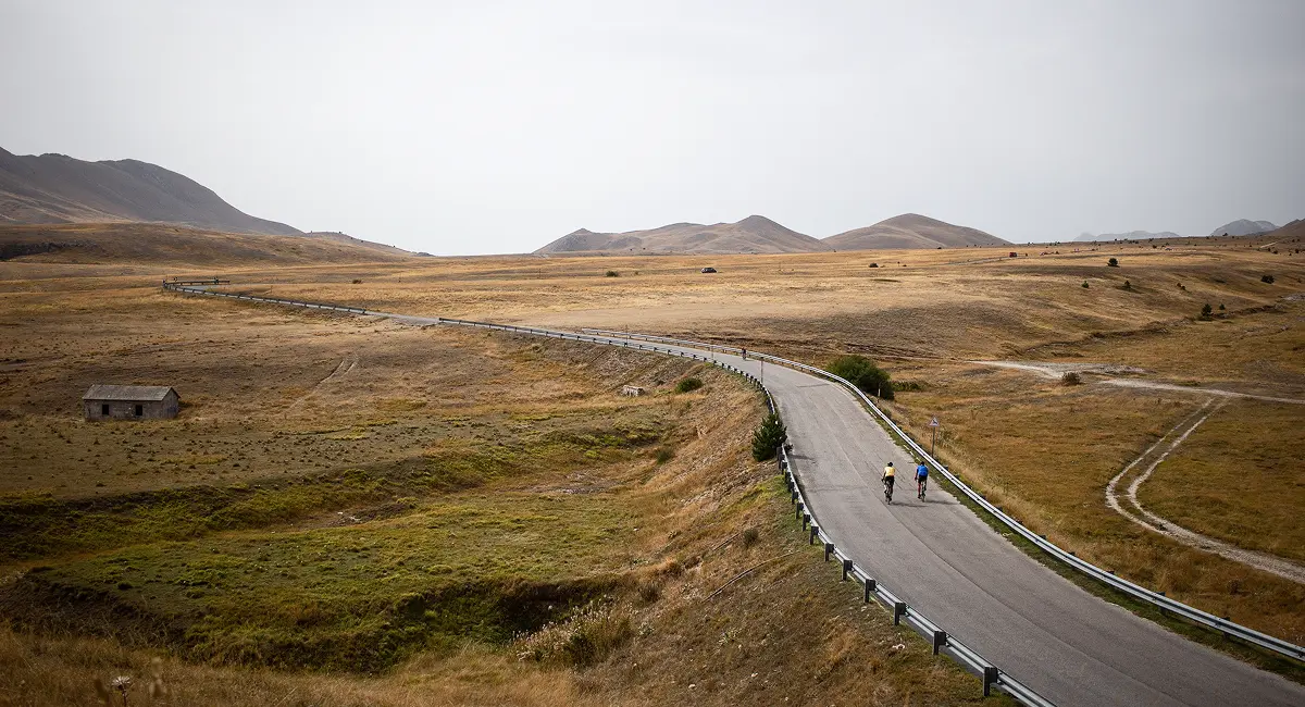 Cyclists riding on the open plateau of Campo Imperatore in Abruzzo