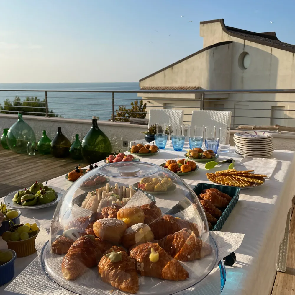 Breakfast table with pastries and sea view terrace during a bike tour in Abruzzo