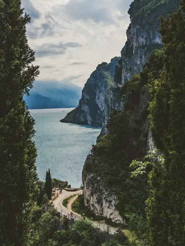 Cycling path carved into the cliffs along Lake Garda offering stunning views of the lake and mountains