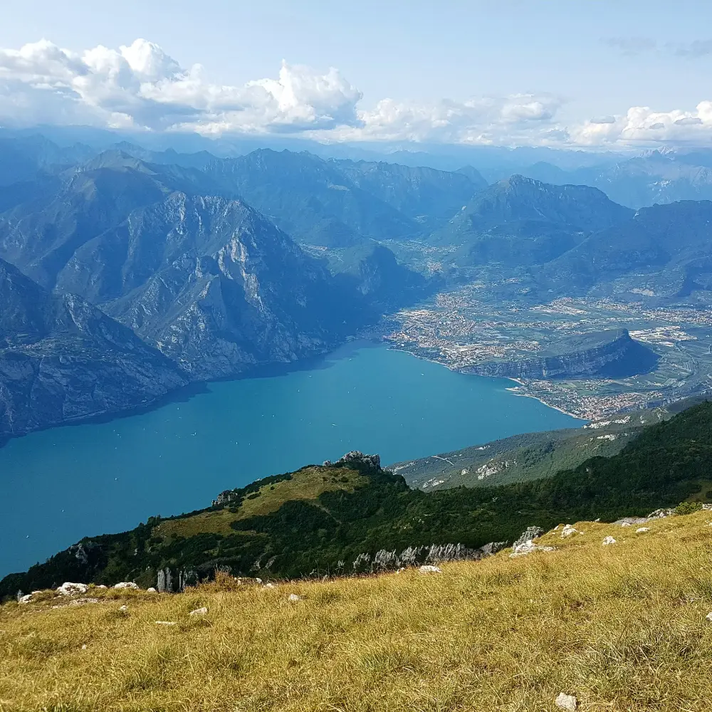 Panoramic view from Monte Baldo overlooking the deep blue waters of Lake Garda and the surrounding mountains