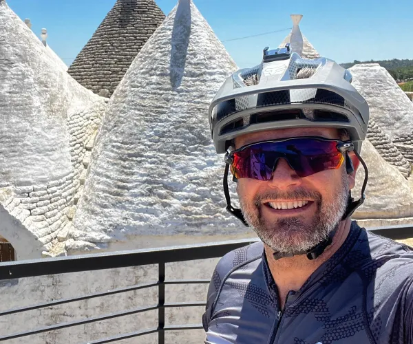 member of Vago Cycling team smiling during a bike tour in Italy
